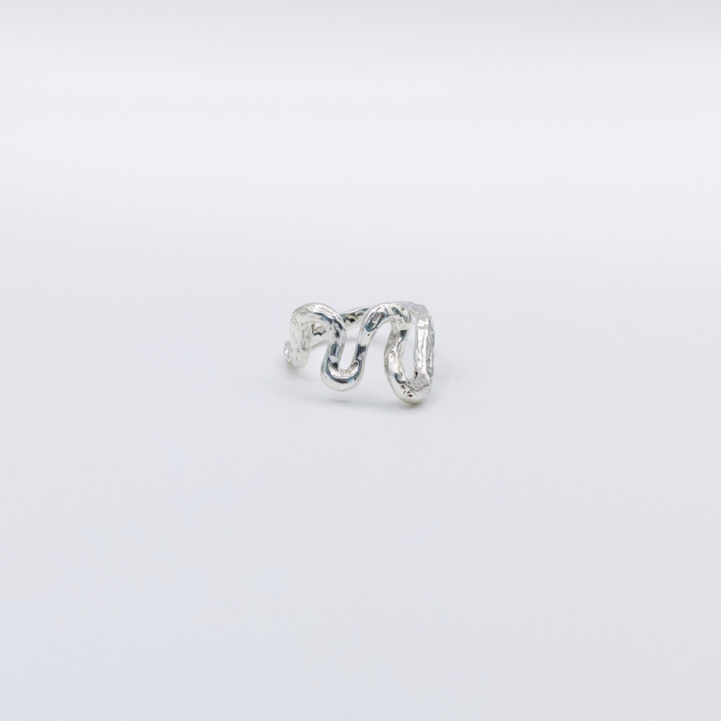 Front view of the Flow silver ring, pictured on a light plain background.