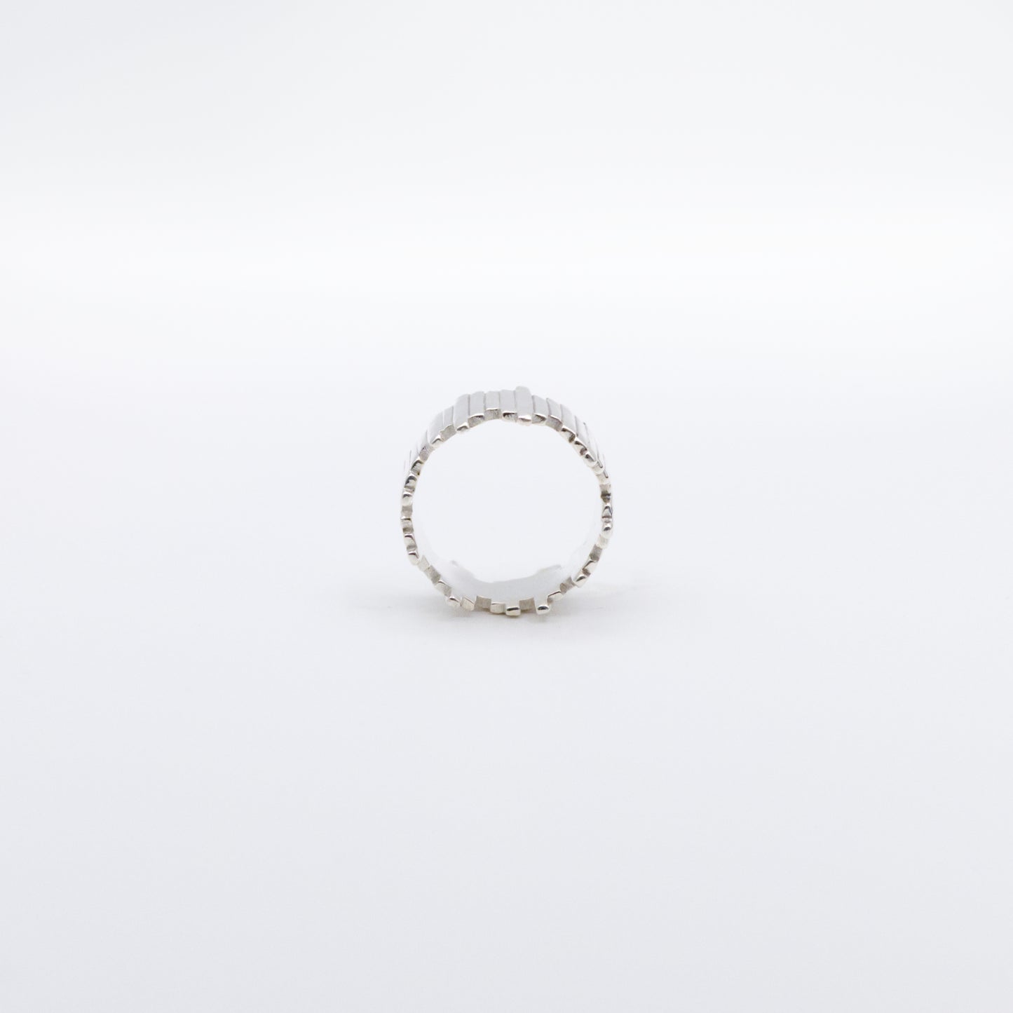 Side view of the Guidance silver ring, pictured on a light plain background.