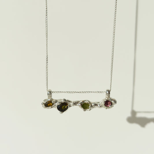 Front view of the Atoll Editions No1 silver necklace, featuring a textured bar pendant with multicolored tourmalines. Shown on a plain light background.