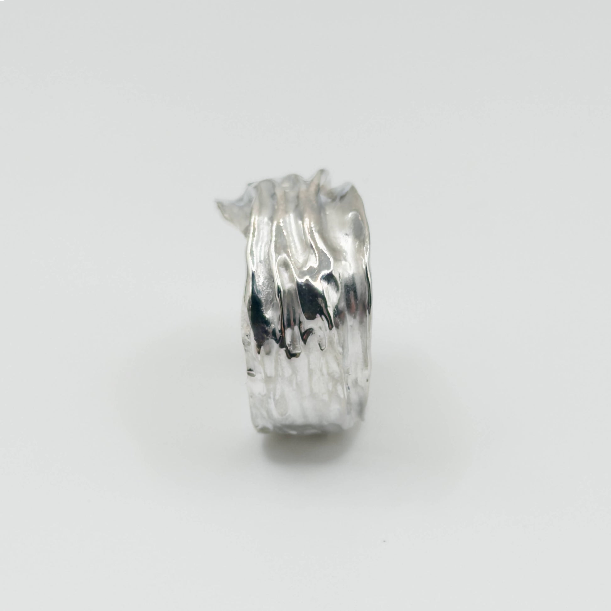 Side view of the Canyon sample silver ring, pictured on a light plain background.