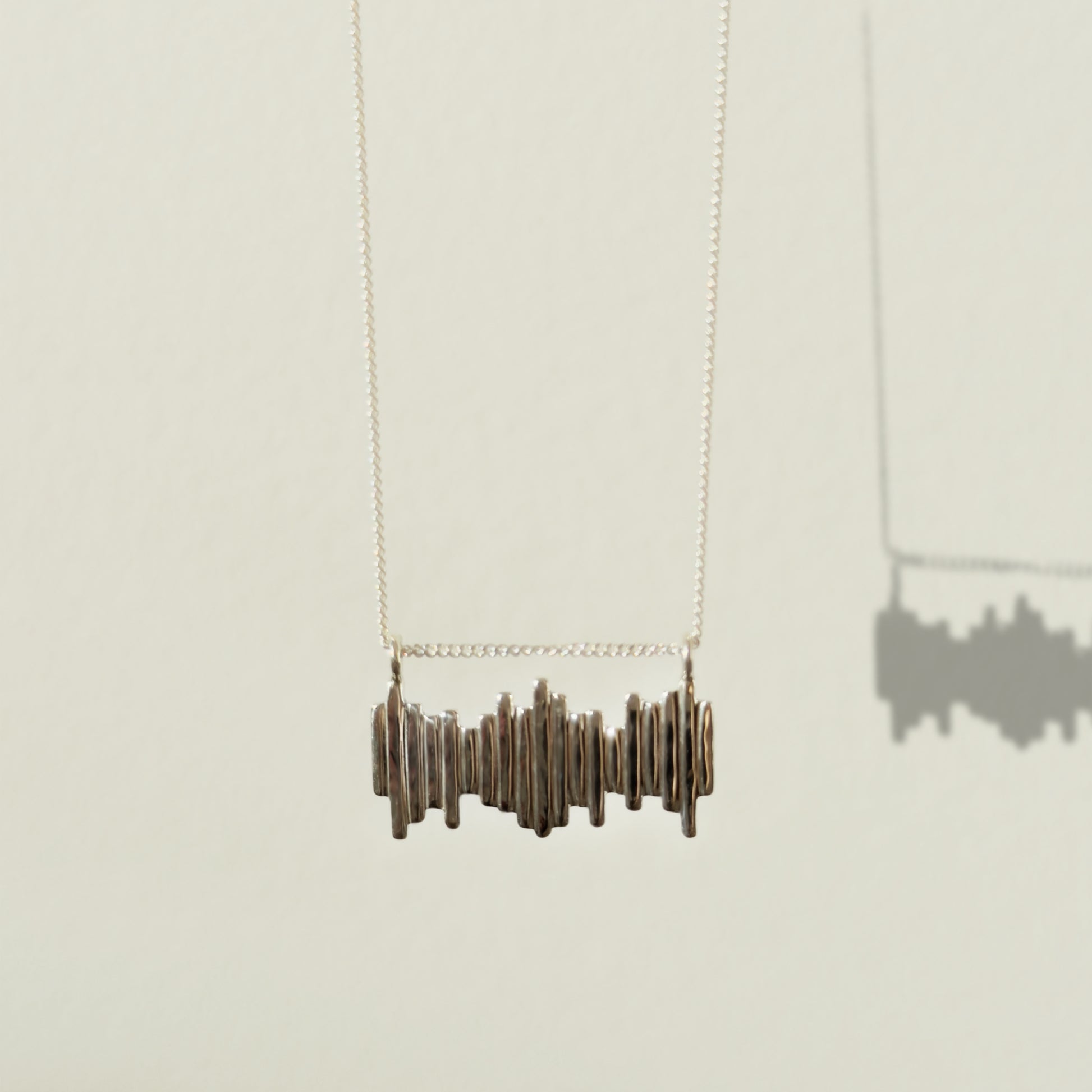 Front view of the Guidance textured silver necklace, pictured on a light plain background.