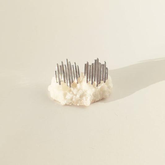 Front view of the Guidance textured silver stud earrings, pictured on a light plain background.