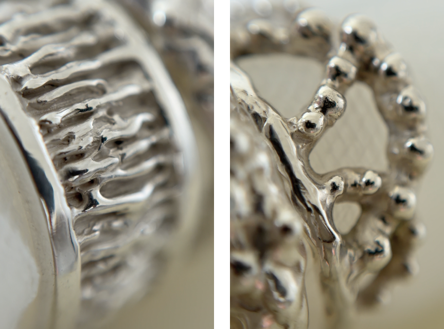 Close-up of two silver rings with highly textured surfaces: one has an organic, tree-like band, the other featuring raised bead-like details. Shown in a split-screen macro view.