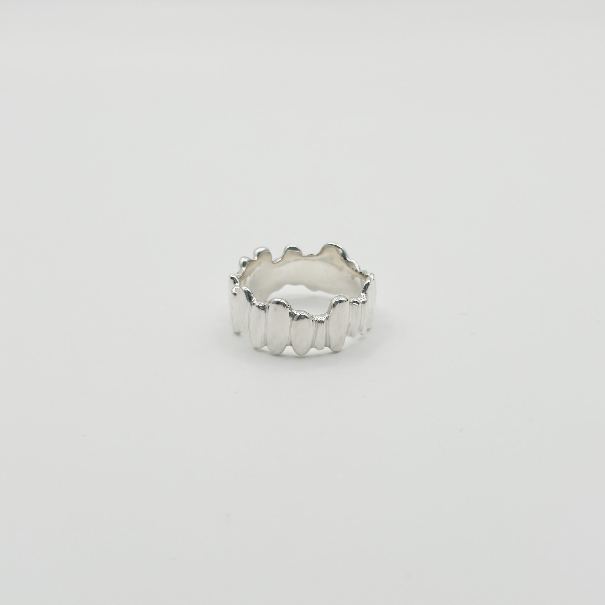Front view of the Meridian textured silver ring, pictured on a light plain background.
