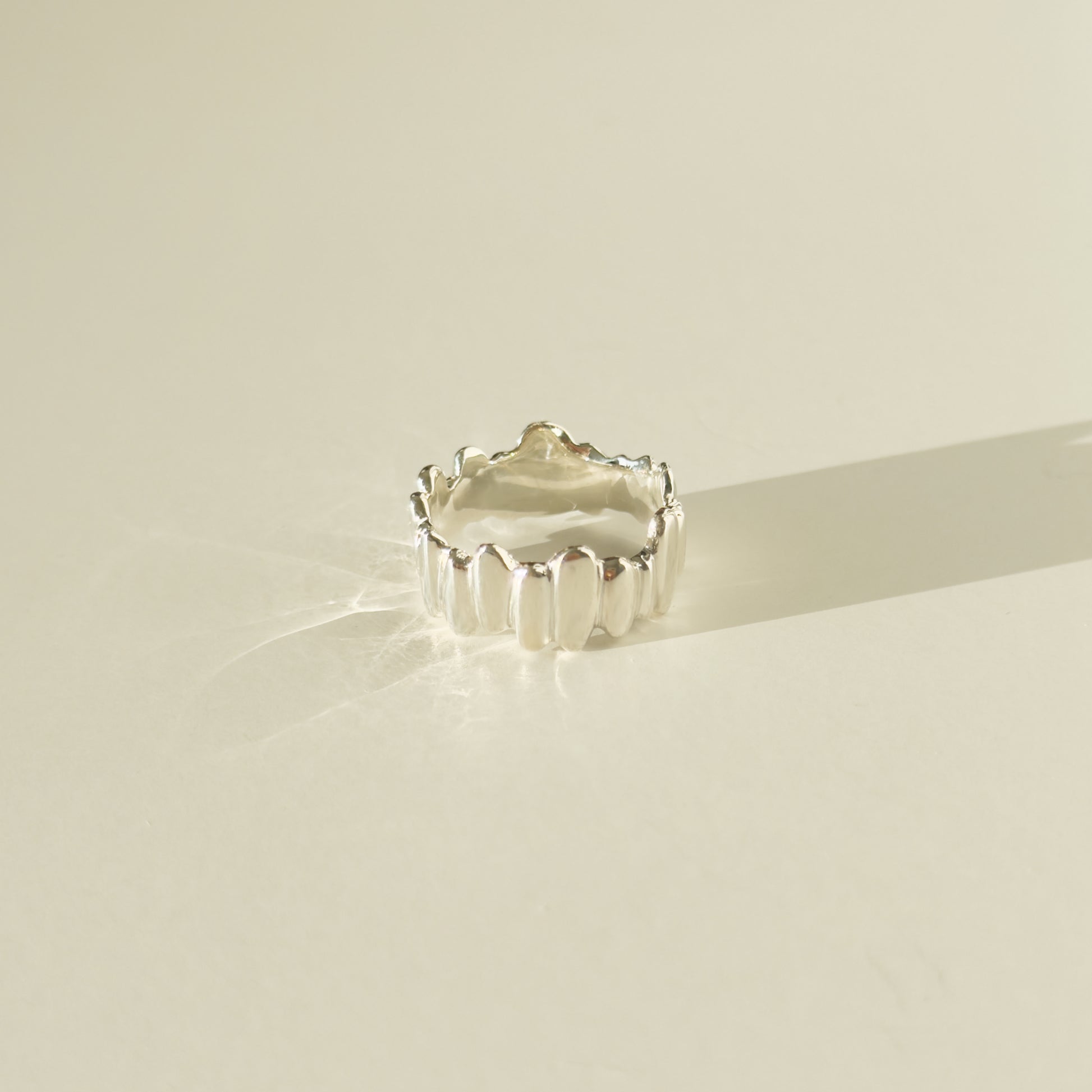 Front view of the Meridian textured silver ring, pictured on a light plain background.