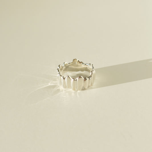 Front view of the Meridian textured silver ring, pictured on a light plain background.