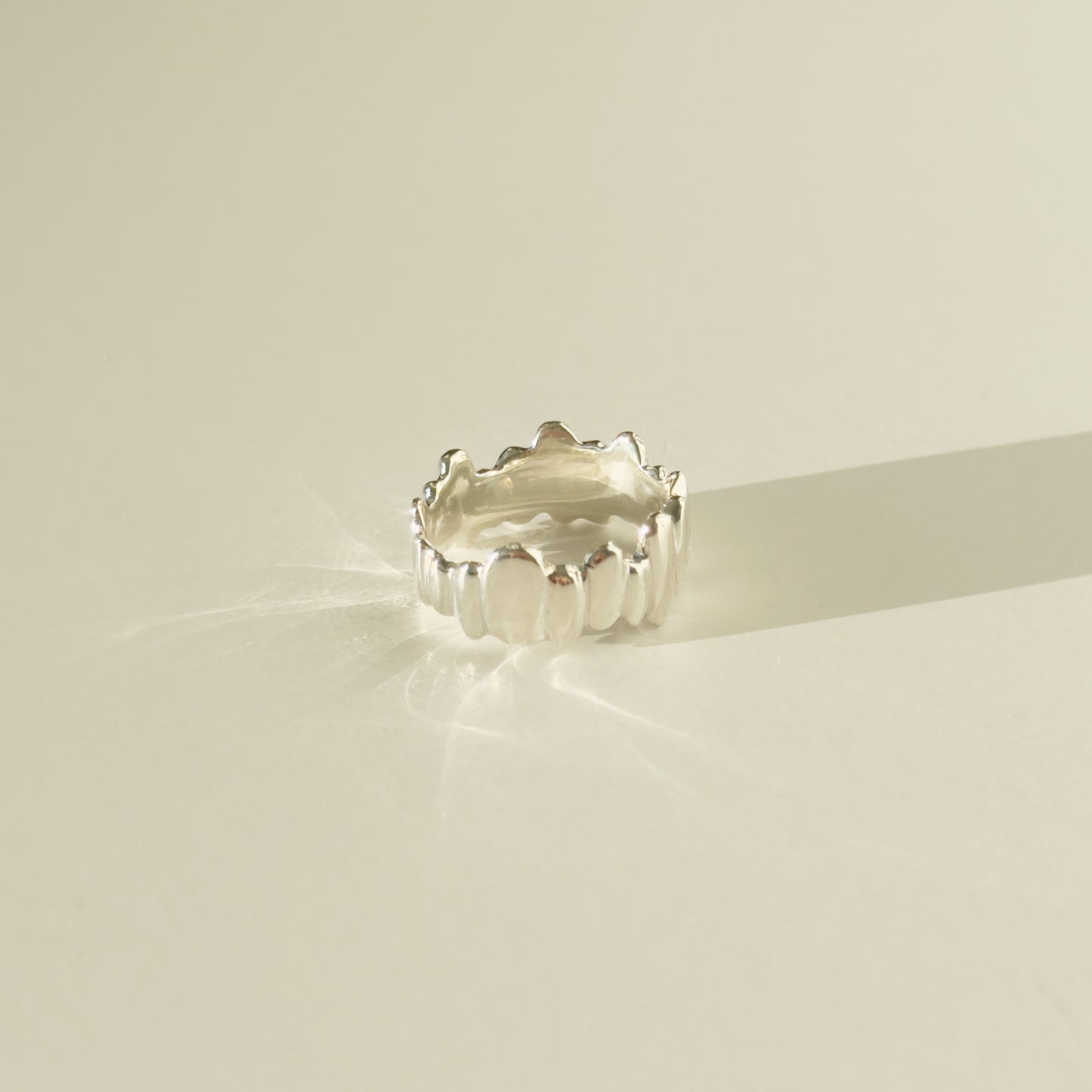 Back view of the Meridian textured silver ring, pictured on a light plain background.