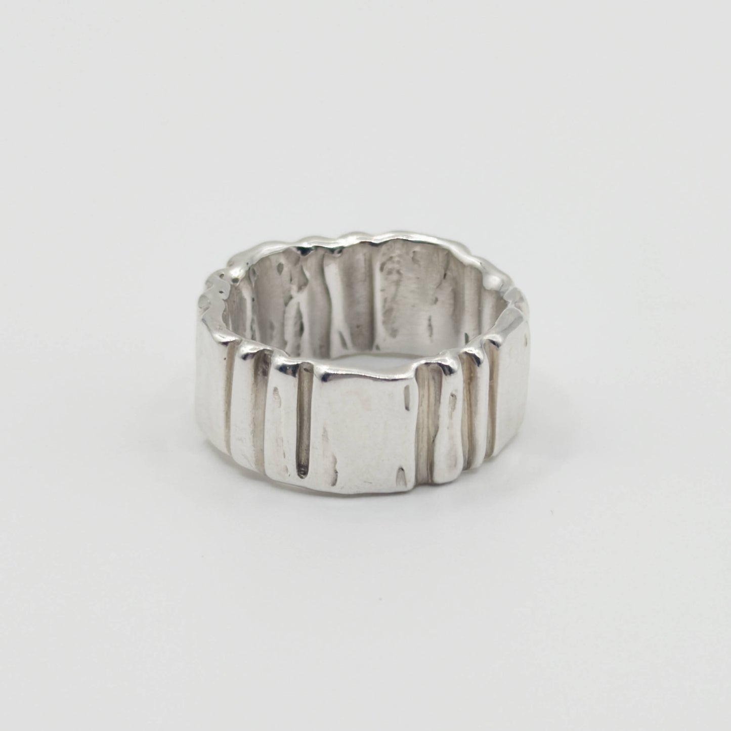 Back view of the Ripple silver ring, pictured on a light plain background.