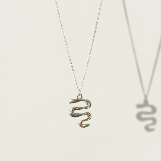 Front view of the Unfold textured silver necklace, pictured on a light plain background.