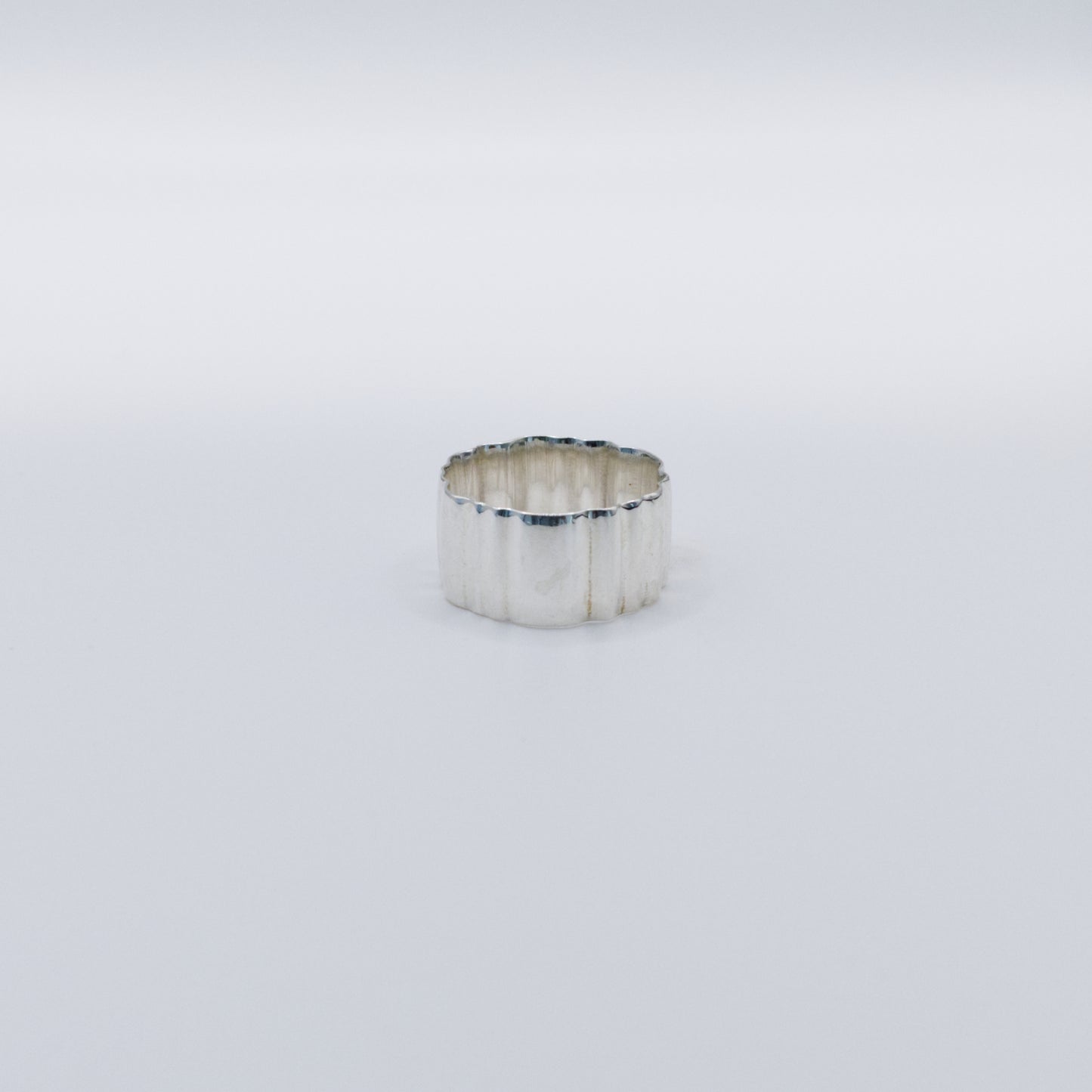 Front view of the Wave silver ring, pictured on a light plain background.