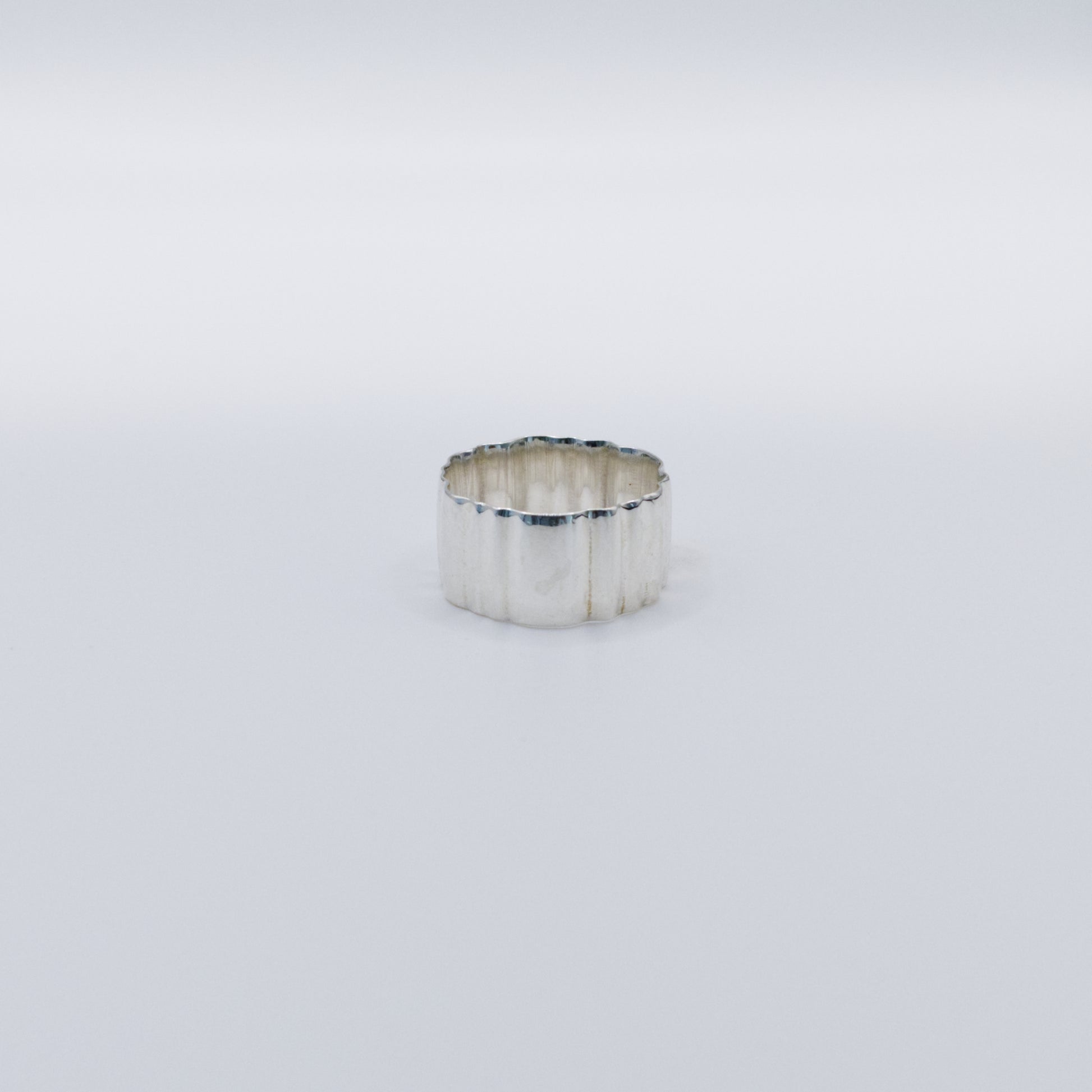 Front view of the Wave silver ring, pictured on a light plain background.