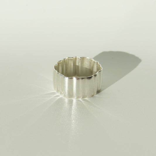Front view of the Wave silver ring, pictured on a light plain background.
